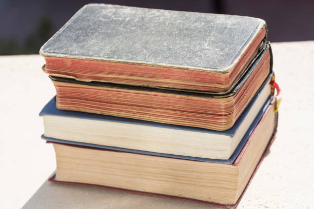 istock Old religious books stacked. New Testament. Religion. 1412252582
