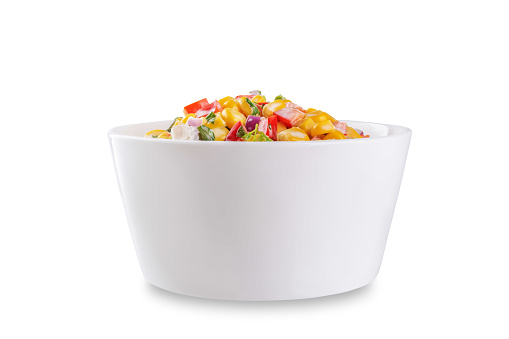 Mexican street corn salad in a bowl on a white isolated background. toning. selective focus