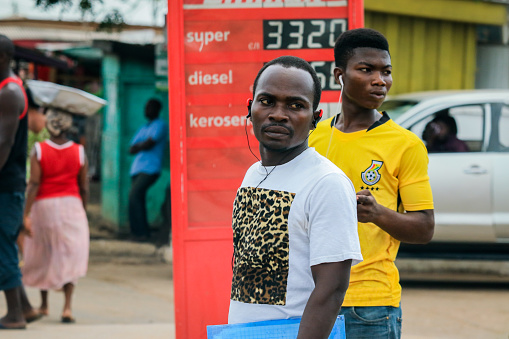 Accra, Ghana - April 06, 2022: Local African Ghana People walking to the daily activities on the Accra Streets