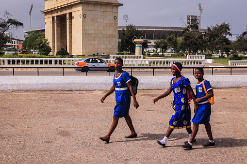 Accra, Ghana - April 06, 2022: Local African Ghana People walking to the daily activities on the Accra Streets