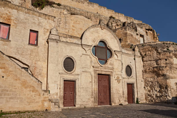 Matera, Basilicata, Italy: the medieval rock church San Pietro Barisano carved into the tuff, in the old town of the ancient Italian city Matera, Basilicata, Italy: the medieval rock church San Pietro Barisano carved into the tuff, in the old town of the ancient Italian city church of san pietro photos stock pictures, royalty-free photos & images