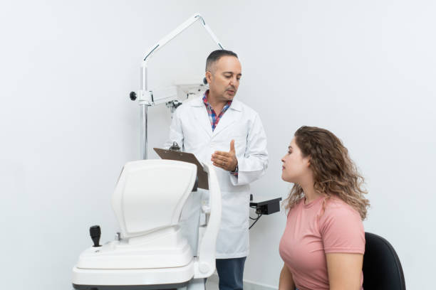 istock Ophthalmologist talking to patient in his office 1412255974