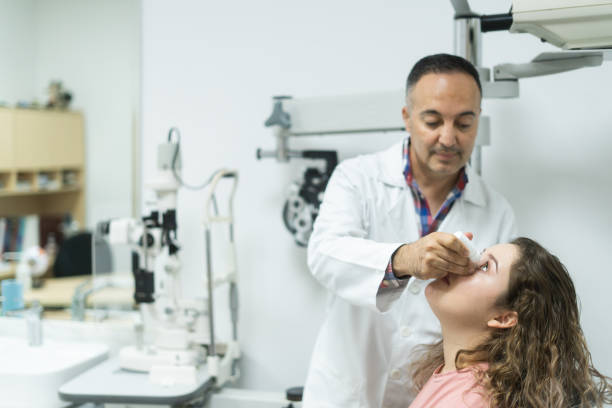 istock Latin ophthalmologist putting drops into woman's eye 1412257285