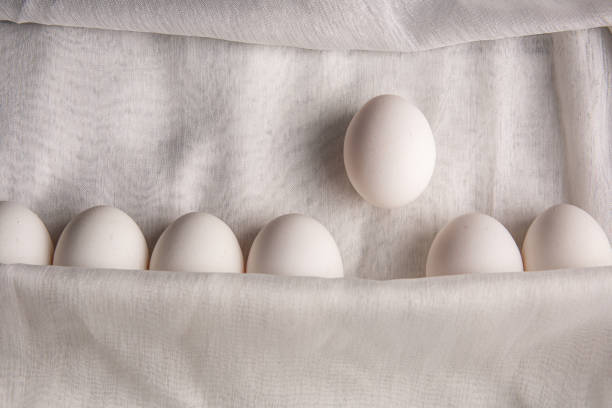 istock Chicken white eggs on the background. Farm products. Natural eggs. Chicken eggs on the table. Chicken eggs in a clay bowl 1412257478