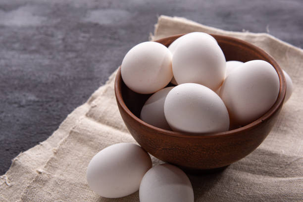 istock Chicken white eggs on the background. Farm products. Natural eggs. Chicken eggs on the table. Chicken eggs in a clay bowl 1412257681