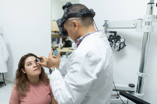 istock Latin woman getting her eyes checked by ophthalmologist 1412257880