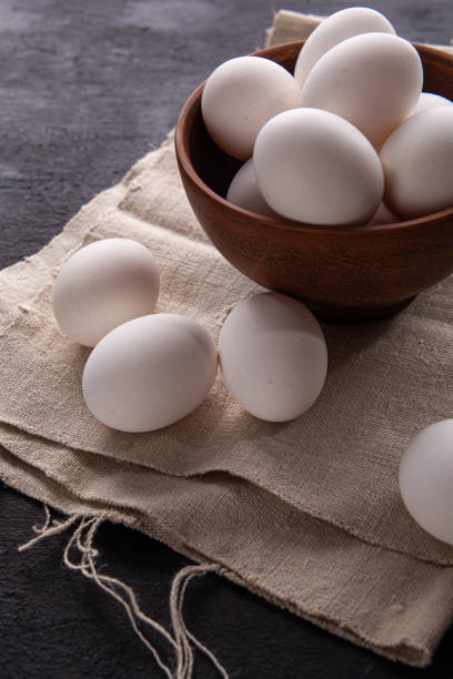 istock Chicken white eggs on the background. Farm products. Natural eggs. Chicken eggs on the table. Chicken eggs in a clay bowl 1412258108