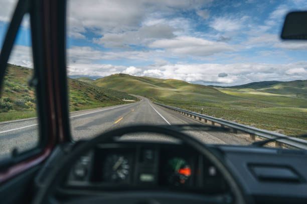 istock POV through vehicle window shield to road 1412259350