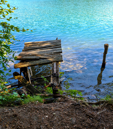 old broken boat landing stage - weathered wood on the lake