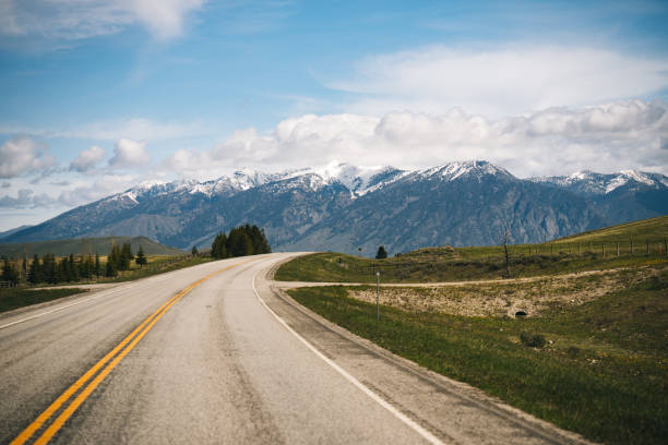 View from road to mountainous landscape Targhee National Forest single yellow line sunlight usa utah stock pictures, royalty-free photos & images