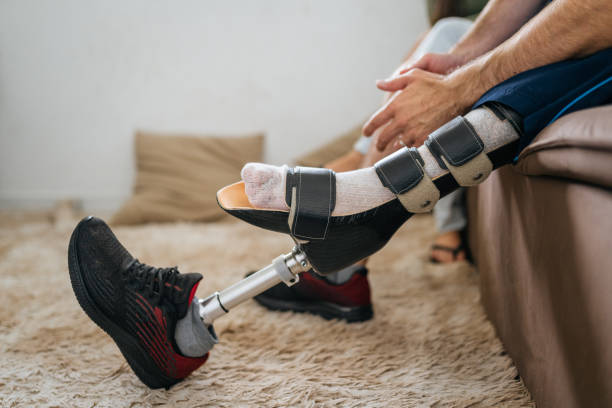 istock Man with leg prosthesis on the sofa 1412262267