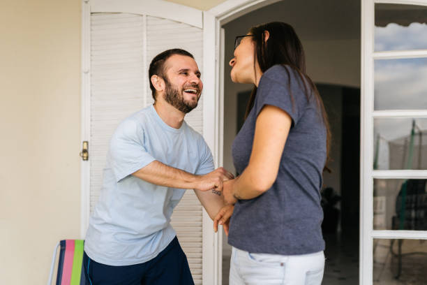 istock Smiling couple at home entrance 1412262281