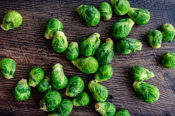 Overhead view of Brussels sprouts on a rustic wooden background