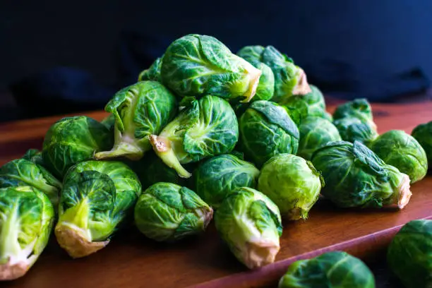 A pile of Brussels sprouts viewed closeup from the side