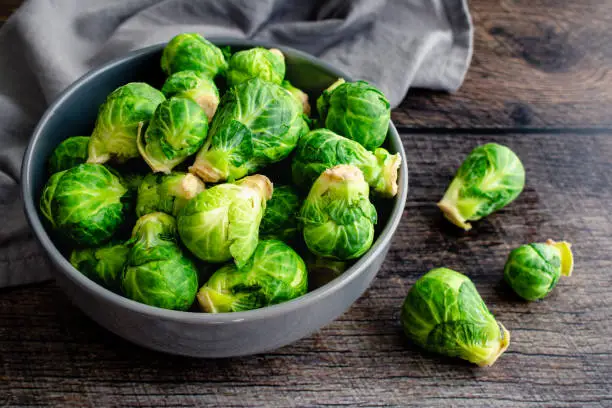Overhead view of Brussels sprouts piled in a porcelain bowl