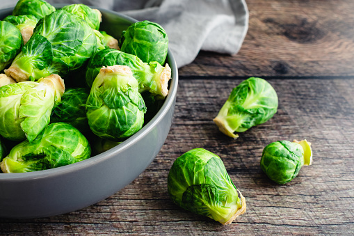 Closeup overhead view of Brussels sprouts piled in a porcelain bowl