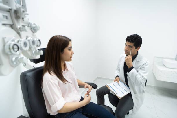 istock Ophthalmologist pointing to his eye to patient 1412265621