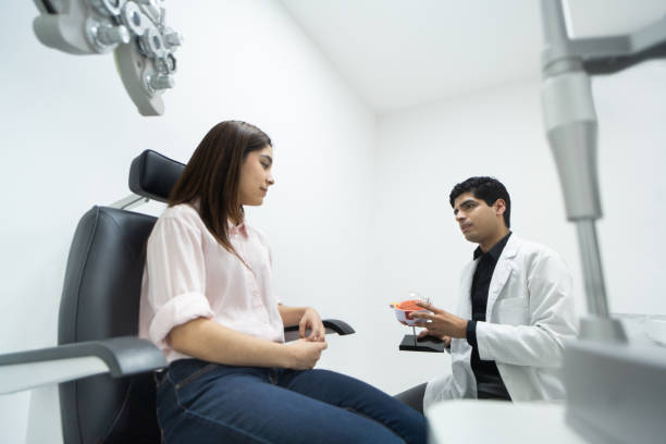 istock Ophthalmologist showing eye model to patient 1412265780