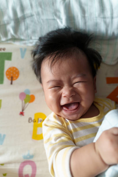 istock Happy little baby boy lying on bed. 1412266914