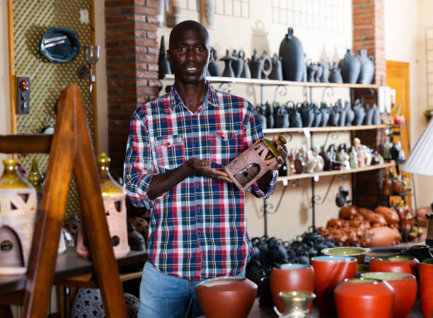 istock Male shop assistant in pottery shop 1412267008