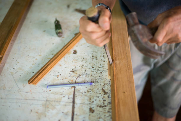 istock Hands of technicians at work repairing woodwork. 1412267350