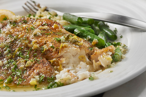 Baked Tilapia in a Lemon, Garlic and Butter Sauce with Green Beans and Rice