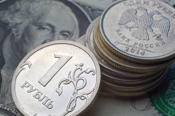 istock Russian 1 ruble coins lie on an American 1 dollar banknote. 1412271414