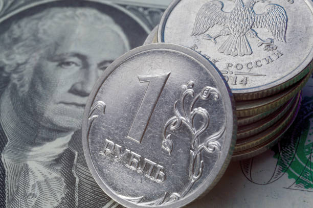 istock Russian 1 ruble coins lie on an American 1 dollar banknote. 1412271432