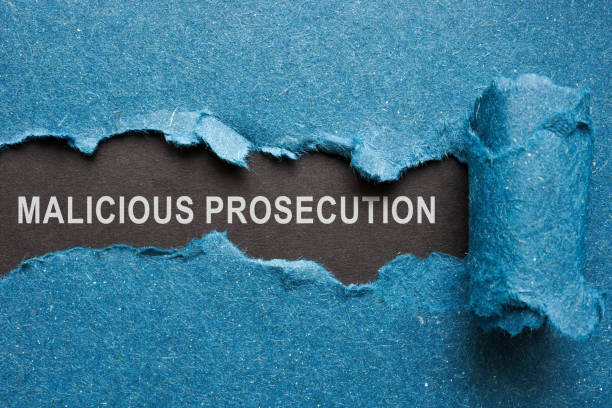 istock Words malicious prosecution on dark paper under blue one. 1412272872