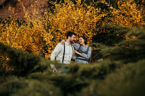 Beautiful young couple in love on a walk outside in the autumn nature.