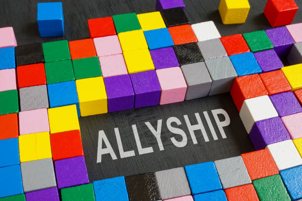 istock Word allyship and colorful cubes on the dark surface. 1412273169
