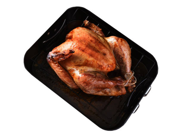 istock High angle view of a cooked Thanksgiving Turkey in a roasting pan isolated on white. 1412273304