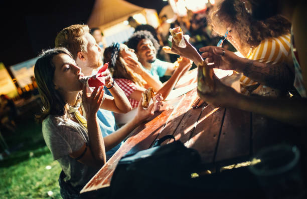 istock Group of friends having a snack during night out. 1412277090