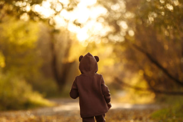 istock Girl with a maple leaf in her hands 1412279882