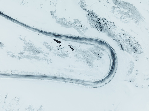 Aerial Drone Shot Of A Curvy Winter Road In the Highlands of Iceland.