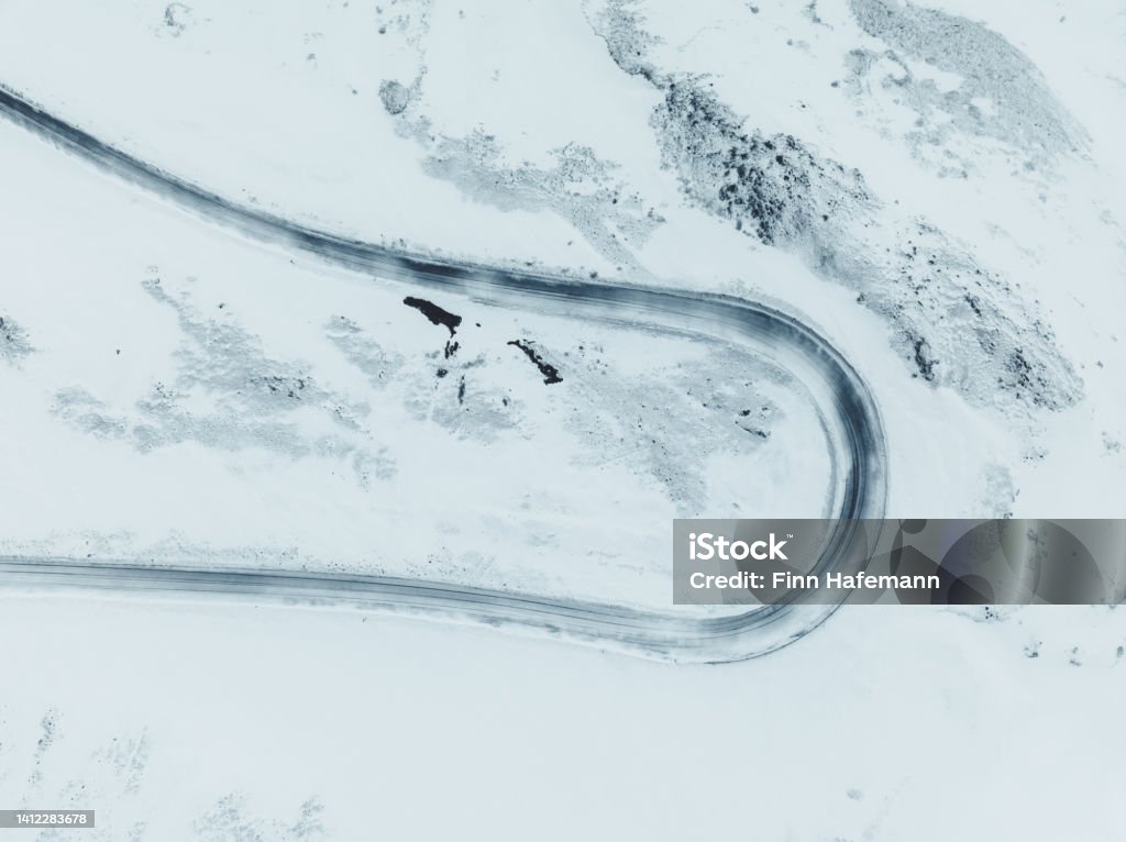Aerial View Of A Curvy Road In Winter Iceland Aerial Drone Shot Of A Curvy Winter Road In the Highlands of Iceland. High Angle View Stock Photo