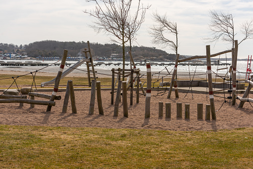 Wooden obstacle course at a playground by a beach.