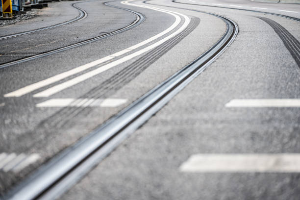 Tram track curve on asphalt road.