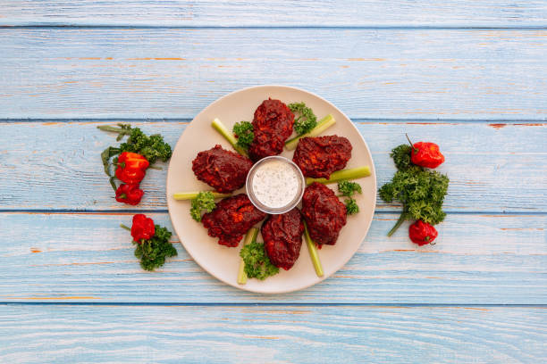 Valle Buffalo Mid Joint Wings with dip and tomato cherry Served in dish isolated on wooden table top view fastfood