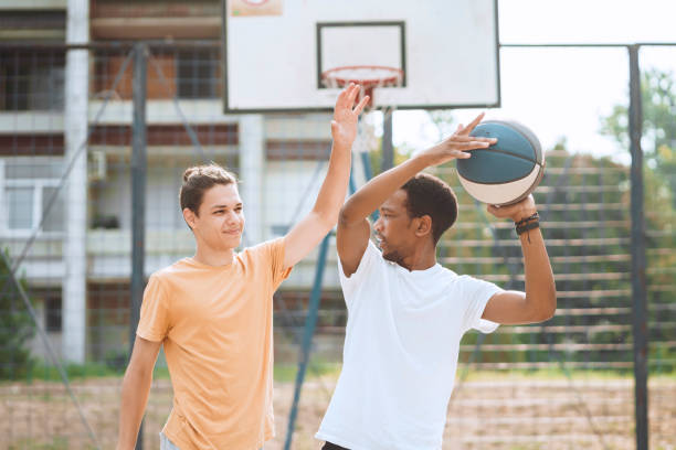 istock Friends playing basketball 1412287213