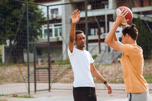 istock Friends playing basketball 1412290485