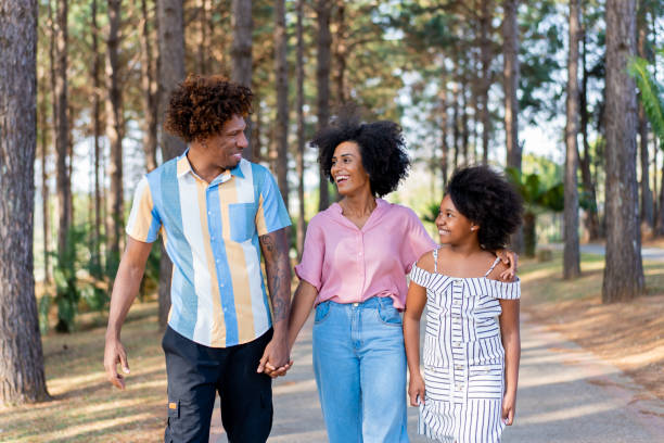 family walking in the park - child women outdoors mother imagens e fotografias de stock