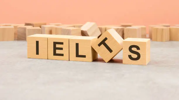 IELTS symbol. Beautiful orange and gray background. Copy space. IELTS - acronym International English Language Testing System