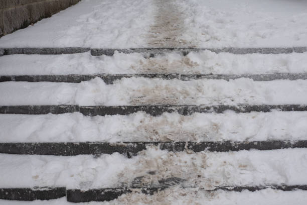 istock concrete stairs covered with snow, cold winter day 1412294416