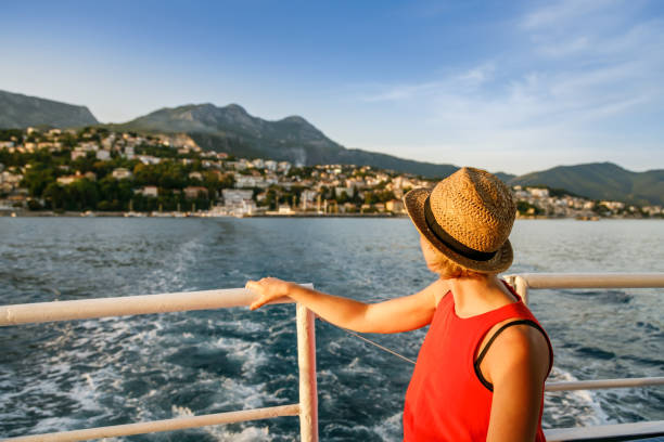 istock Woman looking at Herceg Novi from a boat 1412294529