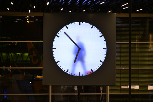 Amsterdam, Netherlands: clock appearing to have a man inside - Amsterdam Airport Schiphol - lounge two at night.