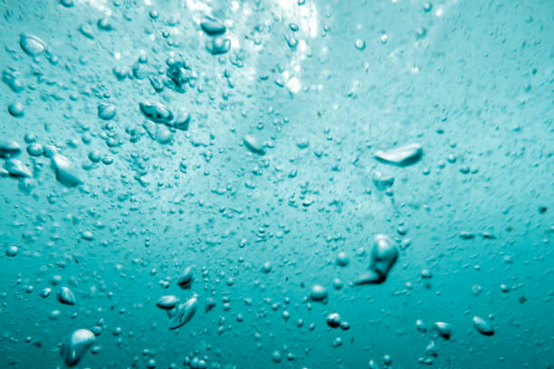 istock Underwater View of Bubbles In Deep Blue Sea. Close Up Water. Background 1412298908