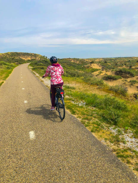 istock Woman on Bicycle Path Noordwijk Netherlands 1412302425