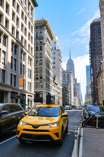 New York City, USA - April 7, 2018: Manhattan NYC buildings of midtown Herald Square Korean Town Korea Way road sign on west 32nd street with yellow taxi cab car