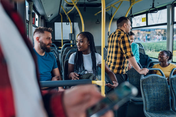 istock Multiracial friends talking while riding a bus in the city 1412305427